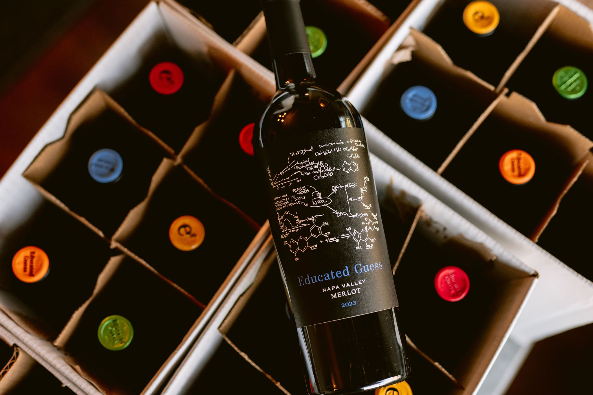 Roots Run Deep case of Educated Guess Wines with colorful tops